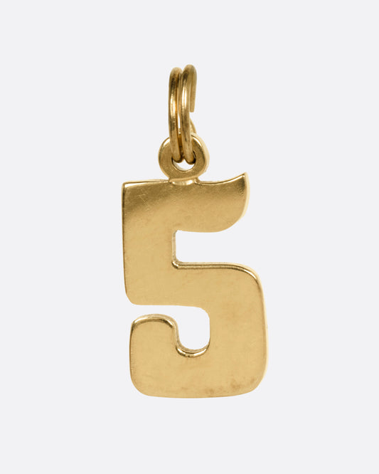 A yellow gold 5 charm, shown from the front.