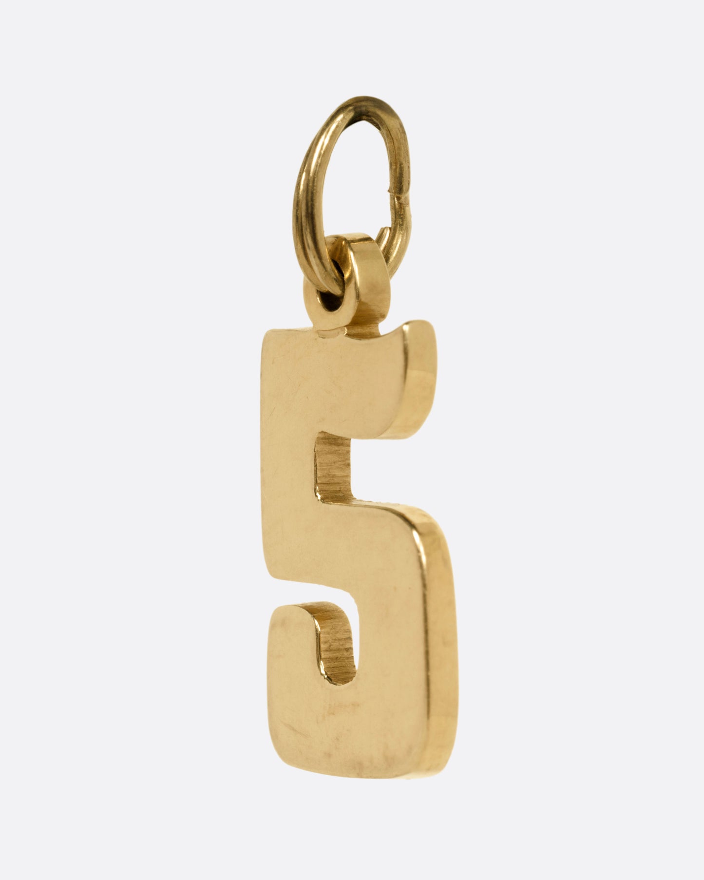A yellow gold 5 charm, shown from the side.