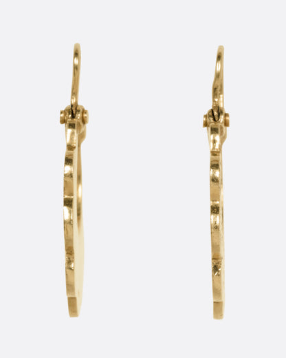 A pair of yellow gold hoop earrings with scalloped edges and floral details, shown from the front.