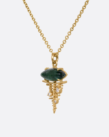 A yellow gold cable chain necklace with a deep green tourmaline cabochon at the top of a diamond studded gold lattice. Shown from the side.
