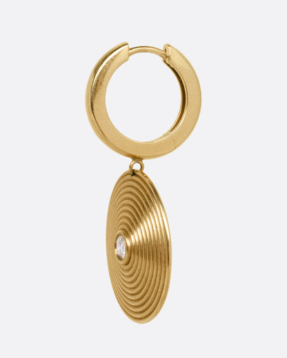 A yellow gold hoop earring with a spiral drop with a white diamond at the center, shown from the side.