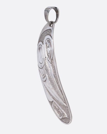 A sterling silver pendant featuring a hand-carved hummingbird design, shown from the side.