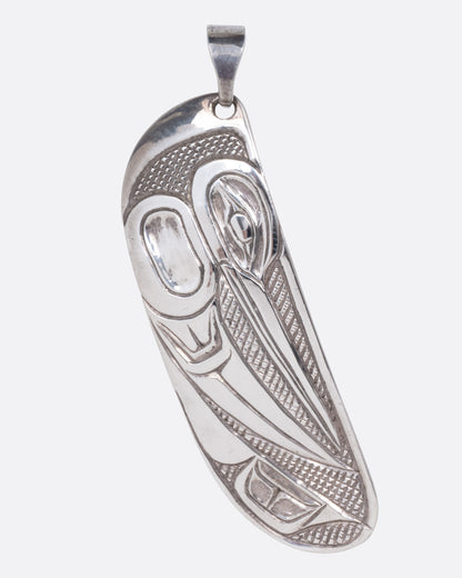 A sterling silver pendant featuring a hand-carved hummingbird design, shown from the front.