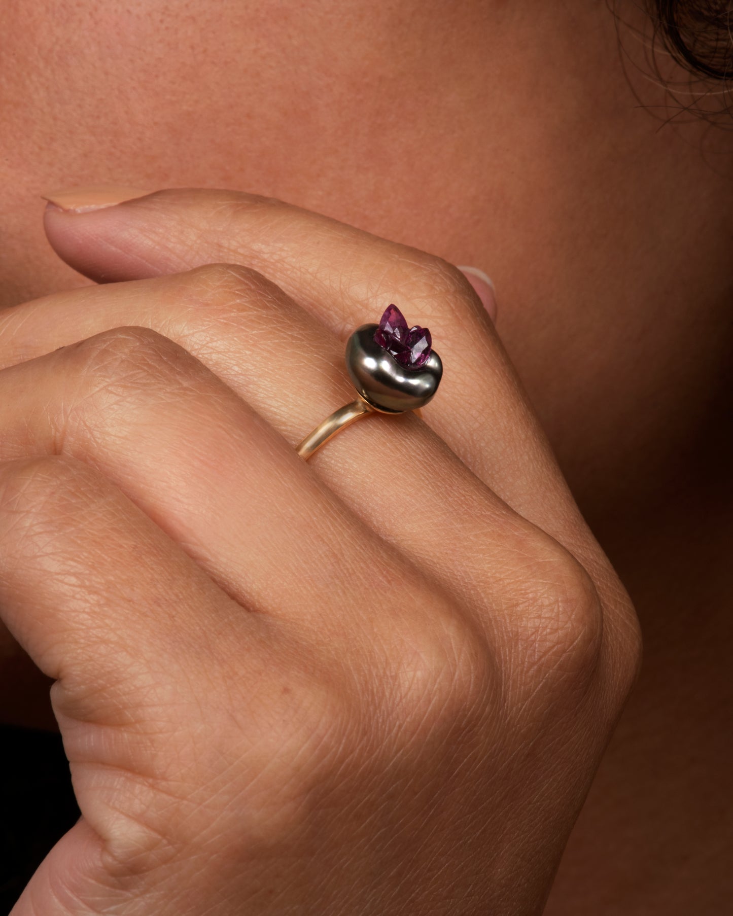 Yellow gold freshwater pearl ring lined with reclaimed rubies. Shown on hand.