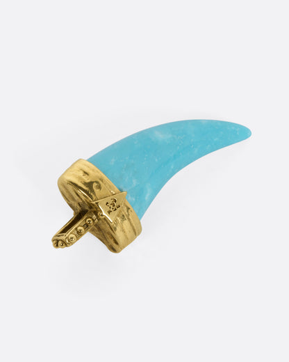 A yellow gold pendant with a sleeping beauty turquoise horn and a marquise ruby, shown from the back.