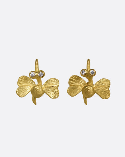 A pair of yellow gold hummingbird stud earrings with diamond eyes, shown from the front.