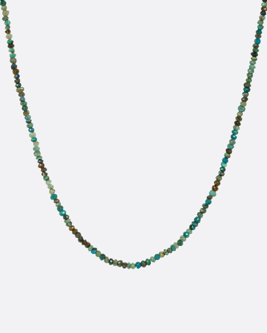 A turquoise beaded necklace shown from the front.