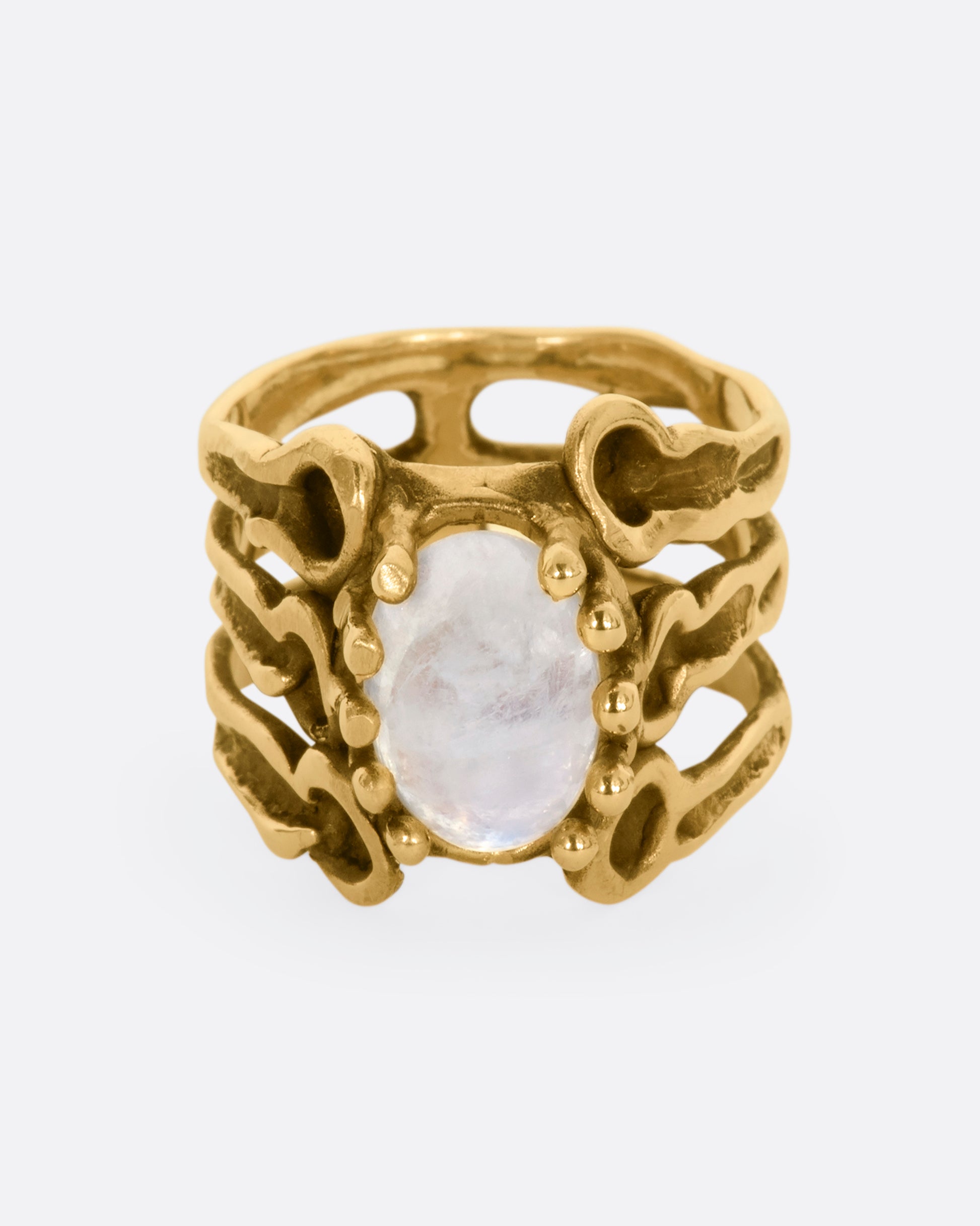 Yellow gold brutalist ring with moonstone cabochon. View from the front.