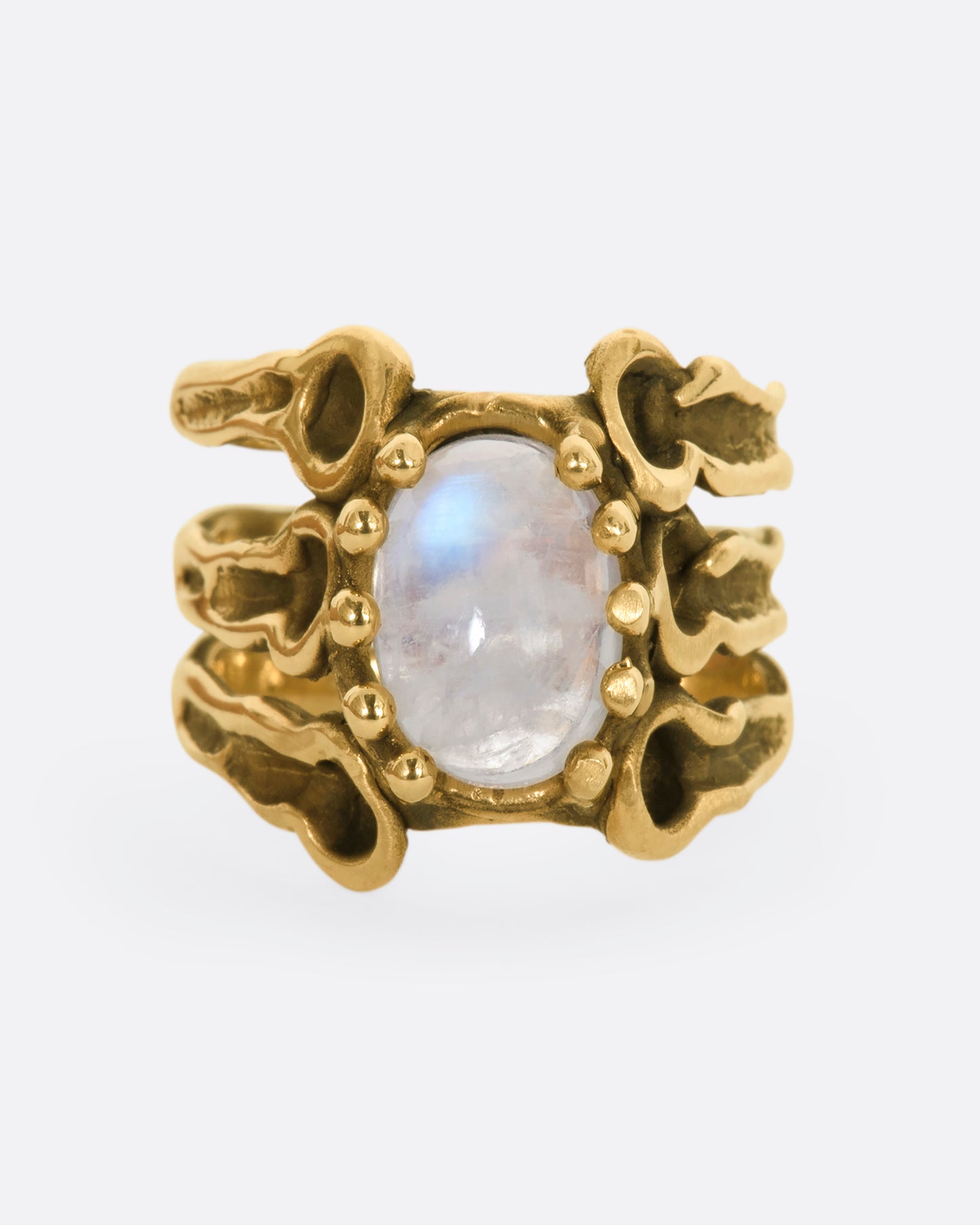 Yellow gold brutalist ring with moonstone cabochon. View from the front.