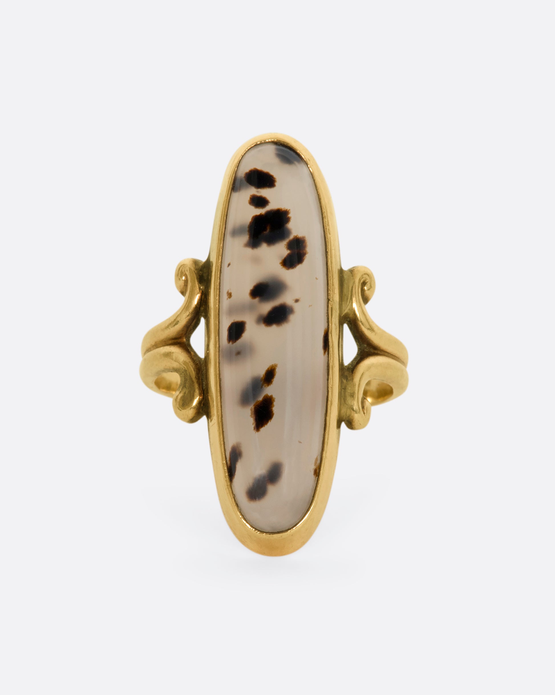 Yellow gold elongated oval agate signet with with swirled shoulders. View from the front.