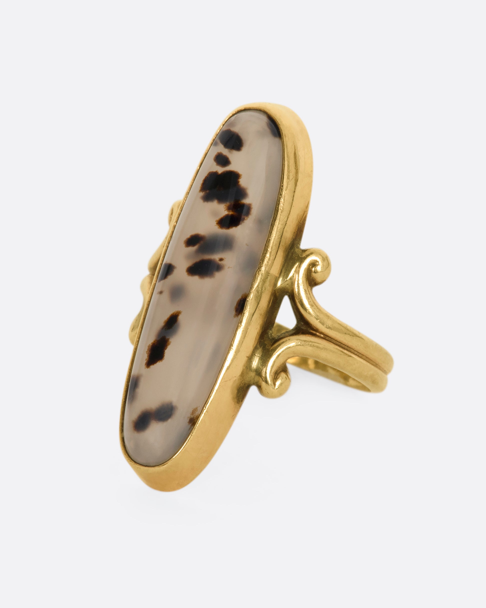 Yellow gold elongated oval agate signet with with swirled shoulders. View from the side.