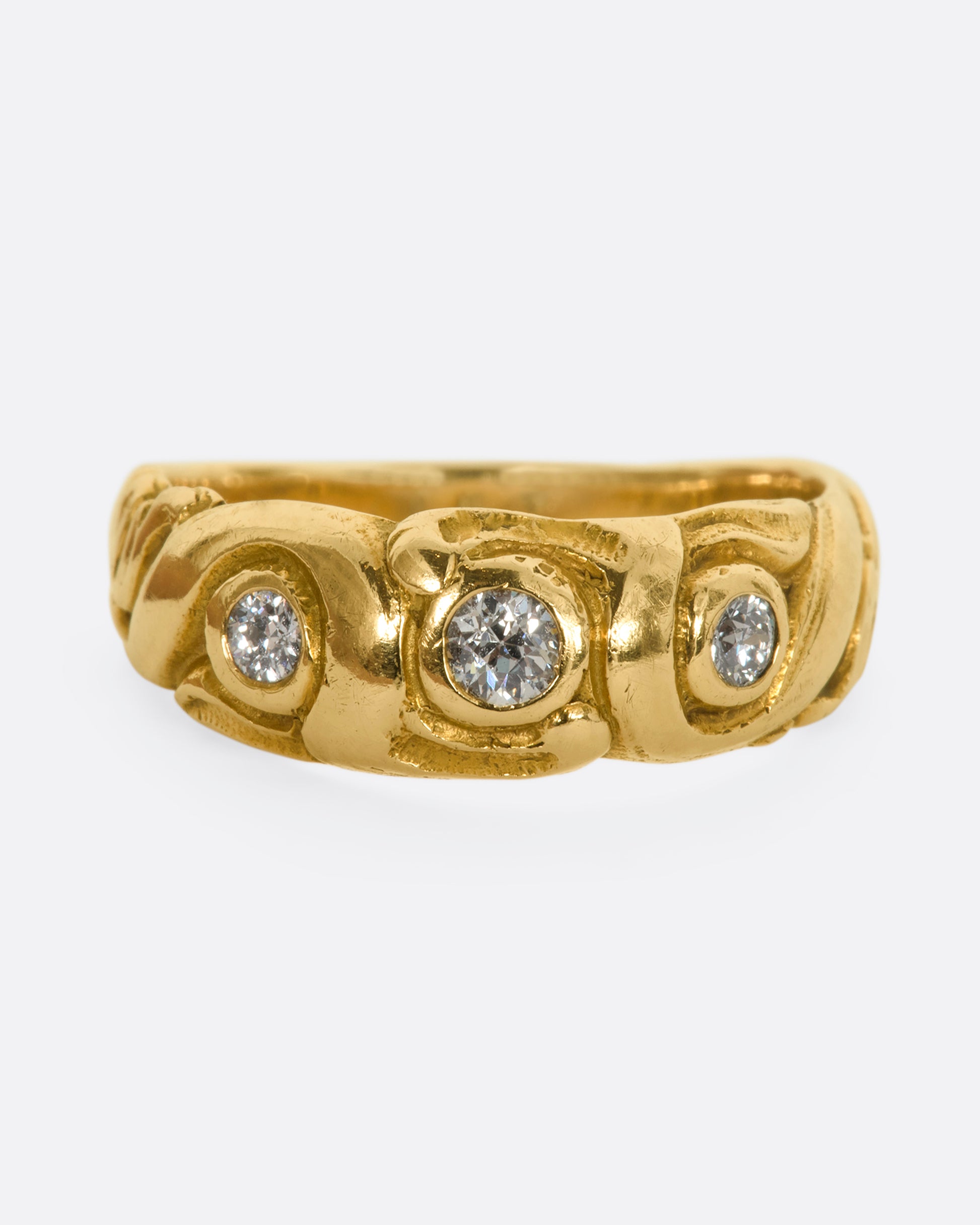 A textured yellow gold ring with three diamonds. View from the front.