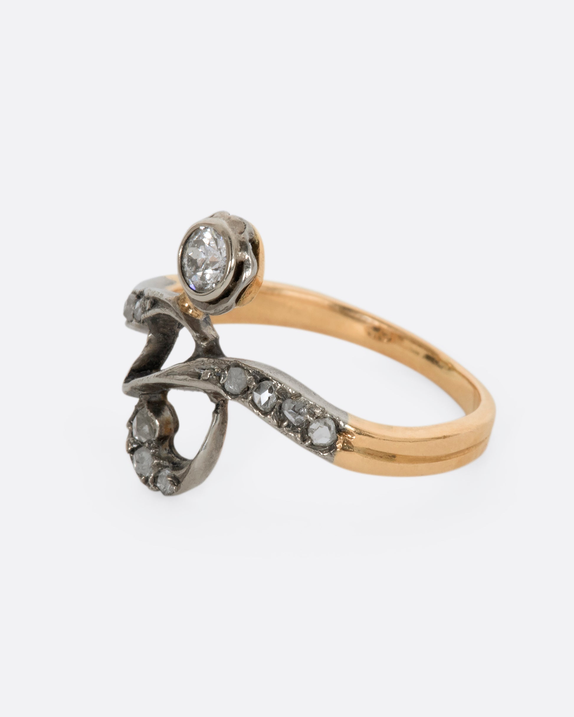 A white and rose gold diamond encrusted abstract ring. View from the alternate side.