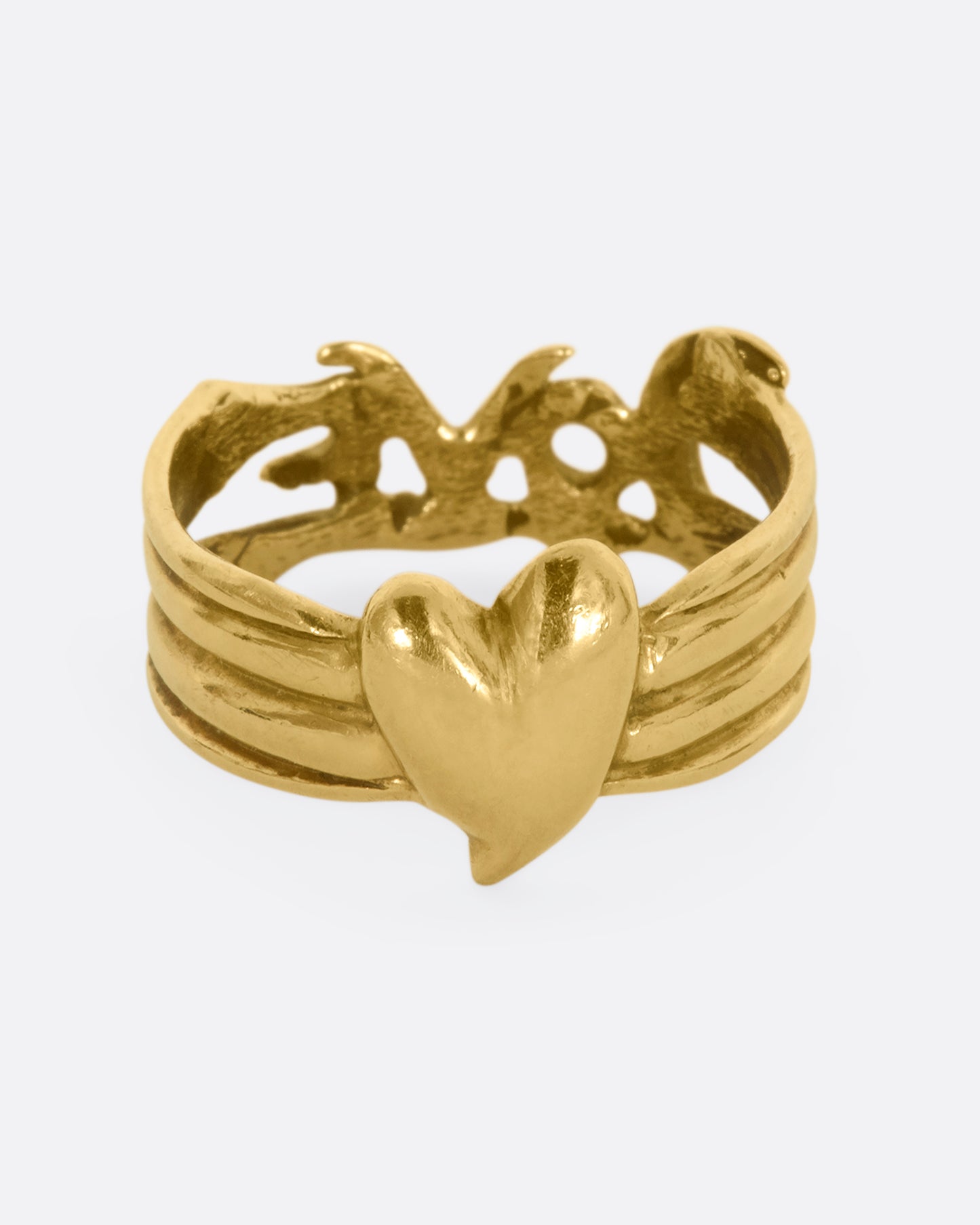 Yellow gold band with a heart on one side and 'Love' written on the other side. View of the heart side.