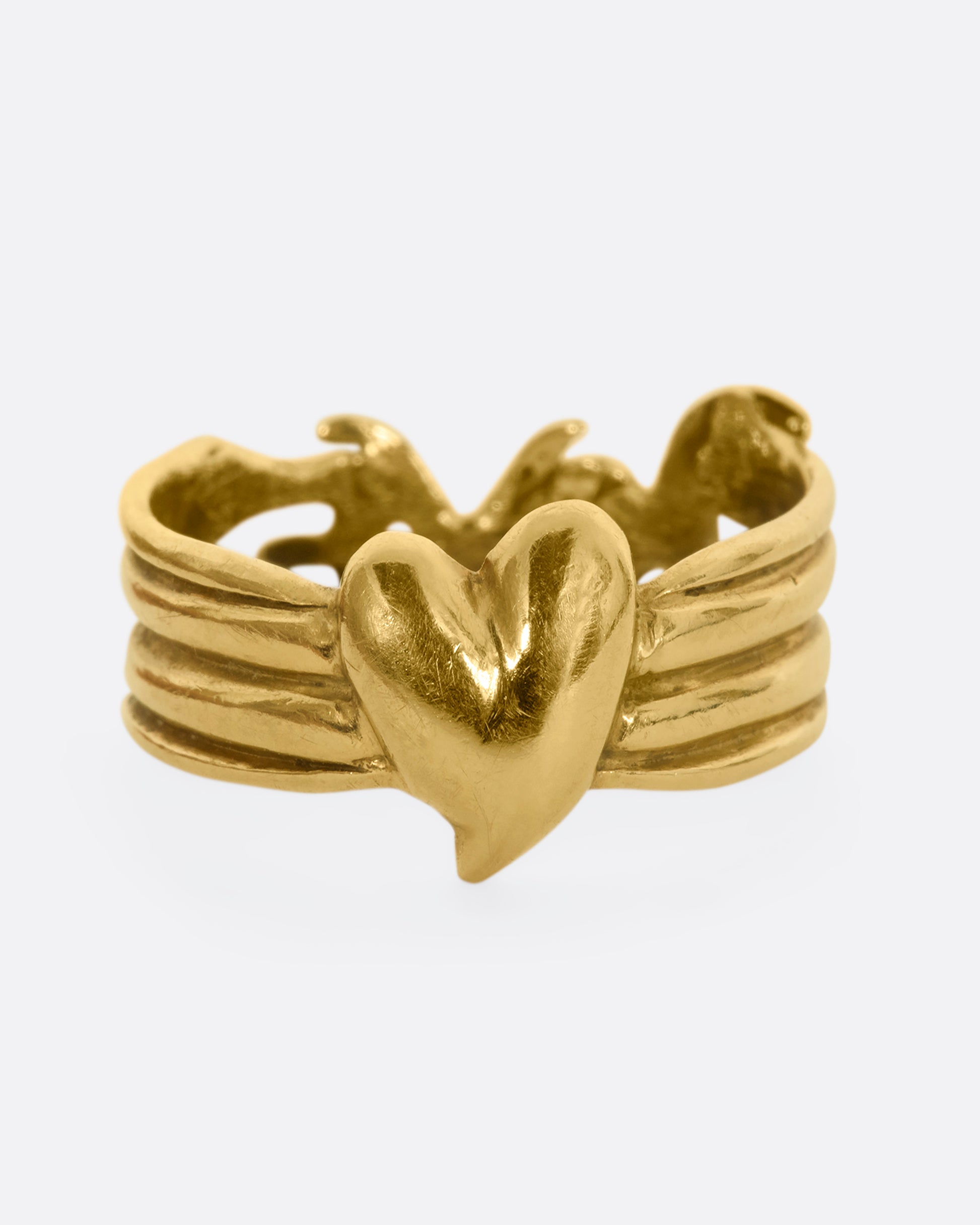 Yellow gold band with a heart on one side and 'Love' written on the other side. View of the heart side.