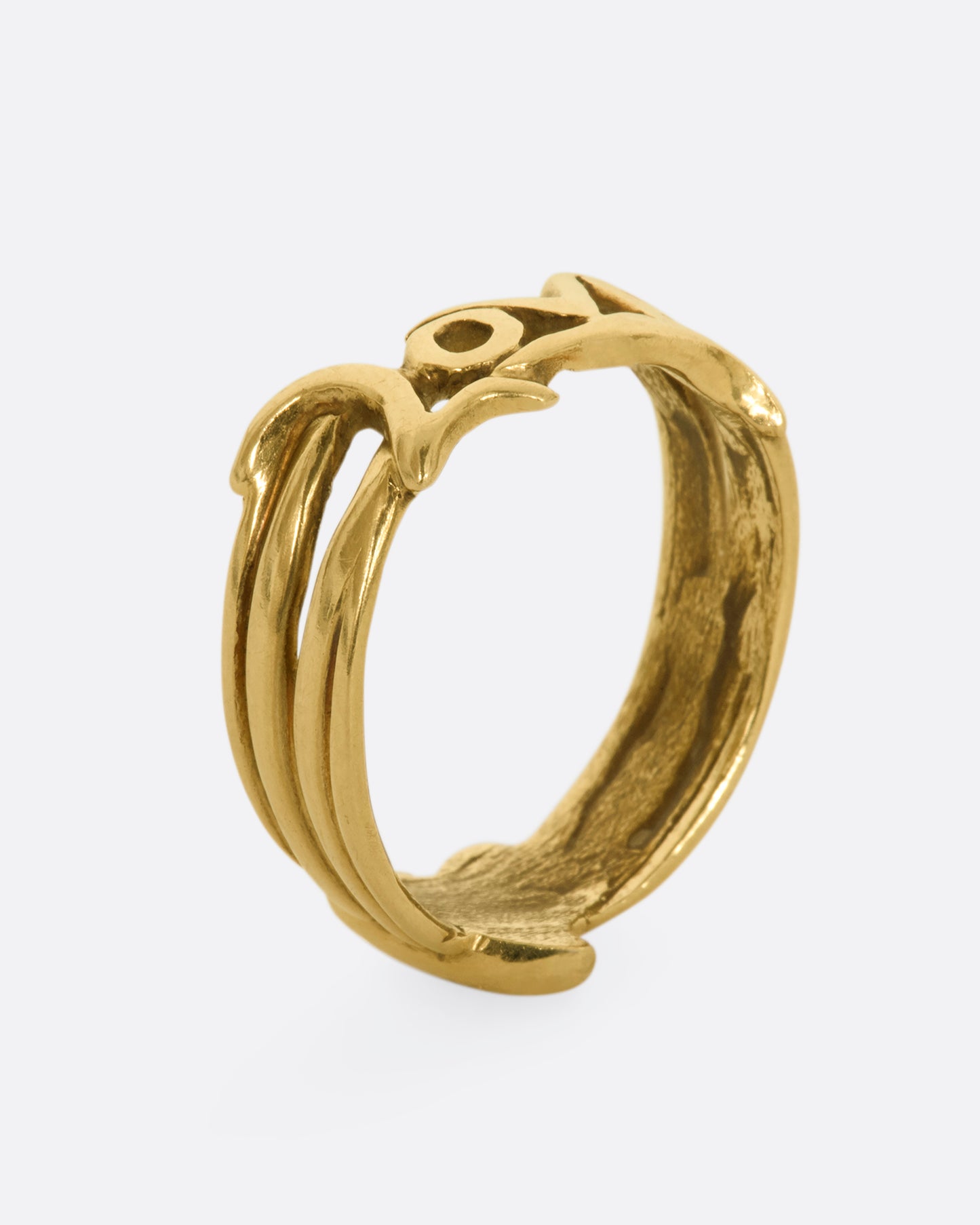 Yellow gold band with a heart on one side and 'Love' written on the other side. View standing up.