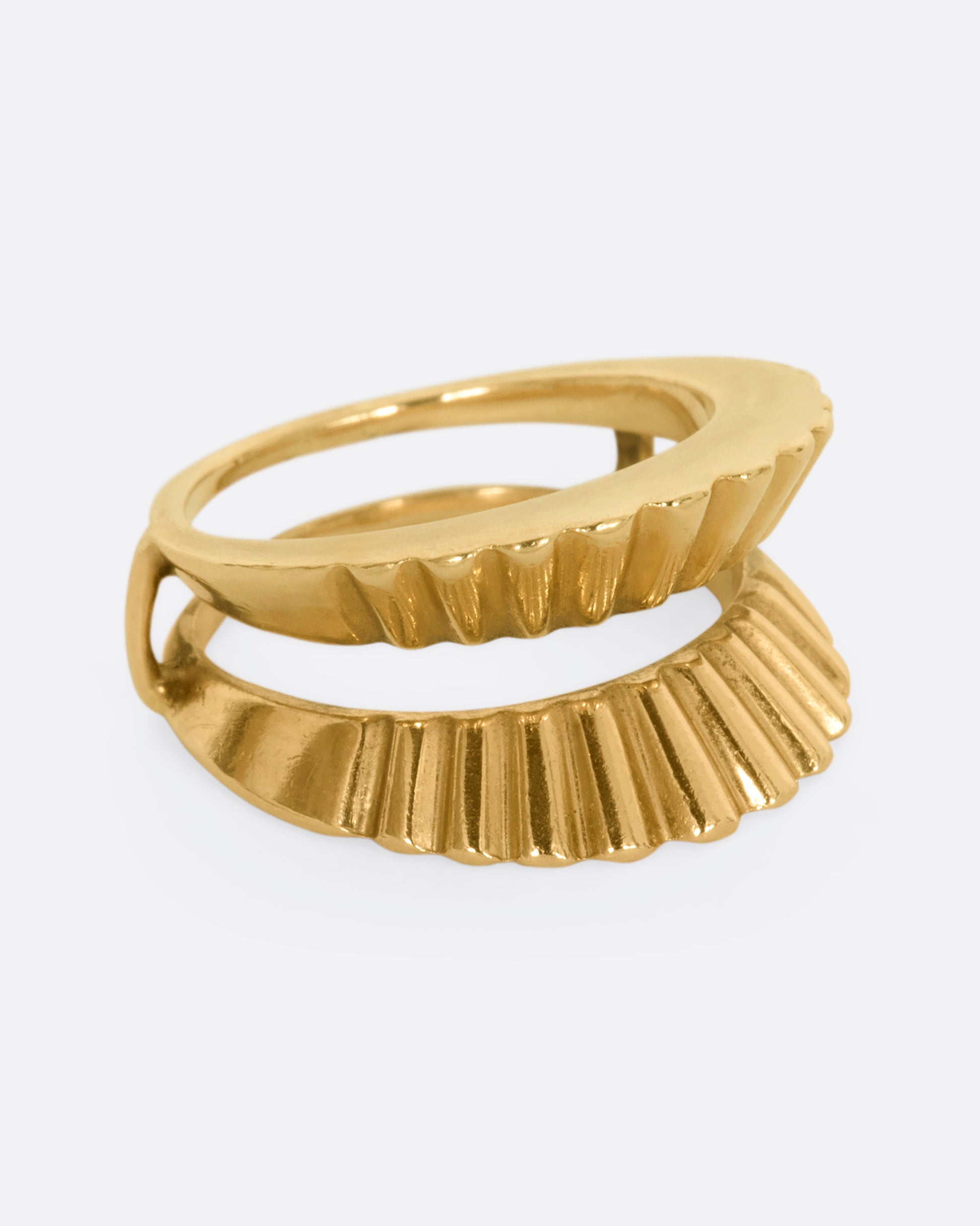 A yellow gold guard ring with a scalloped edge. Shown from the side.