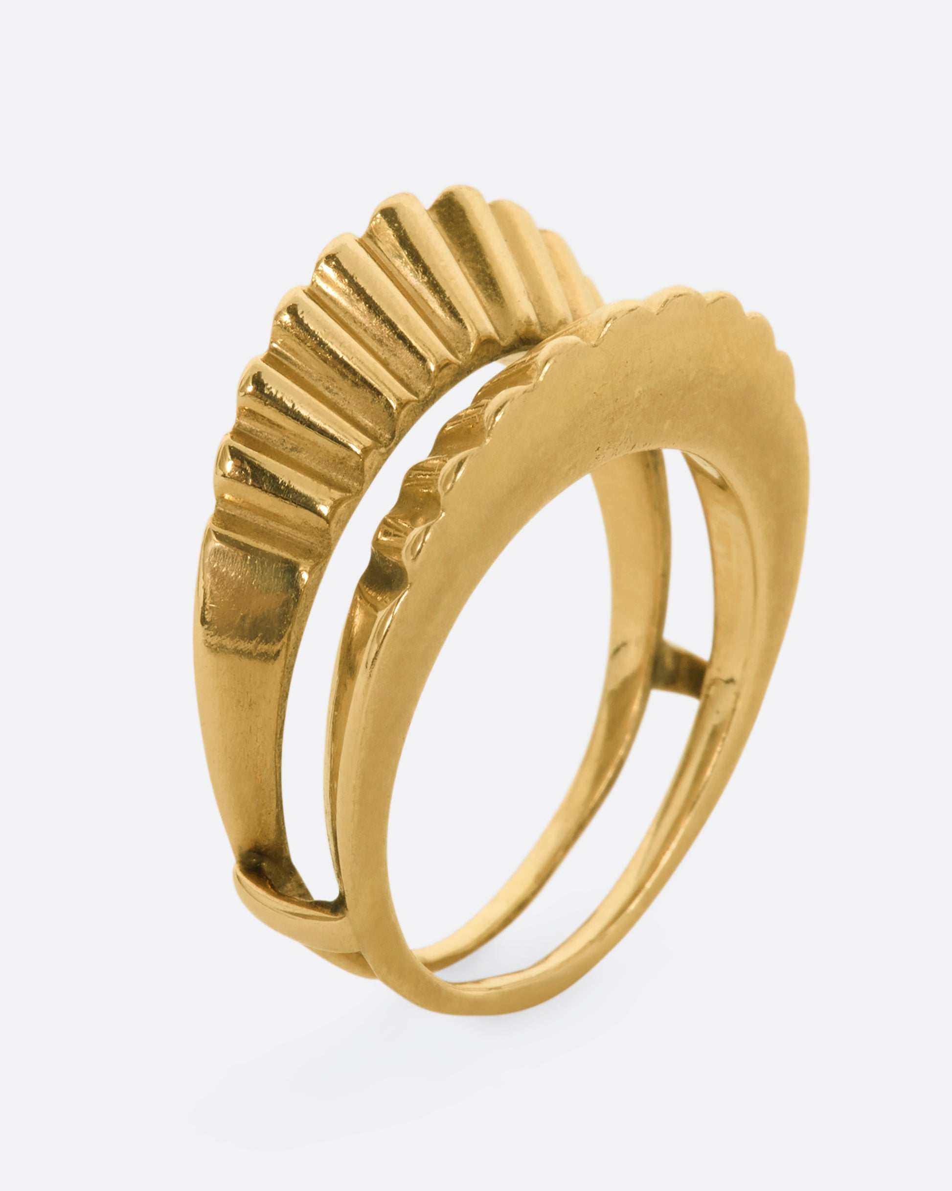 A yellow gold guard ring with a scalloped edge. Shown from the side, standing up.