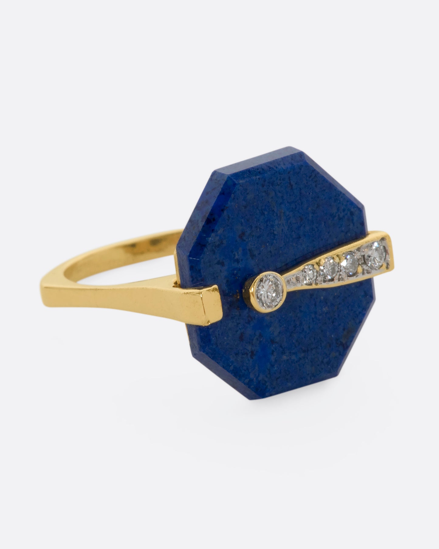 A yellow gold right with an octagonal lapis and diamond exclamation point. View from the other side.