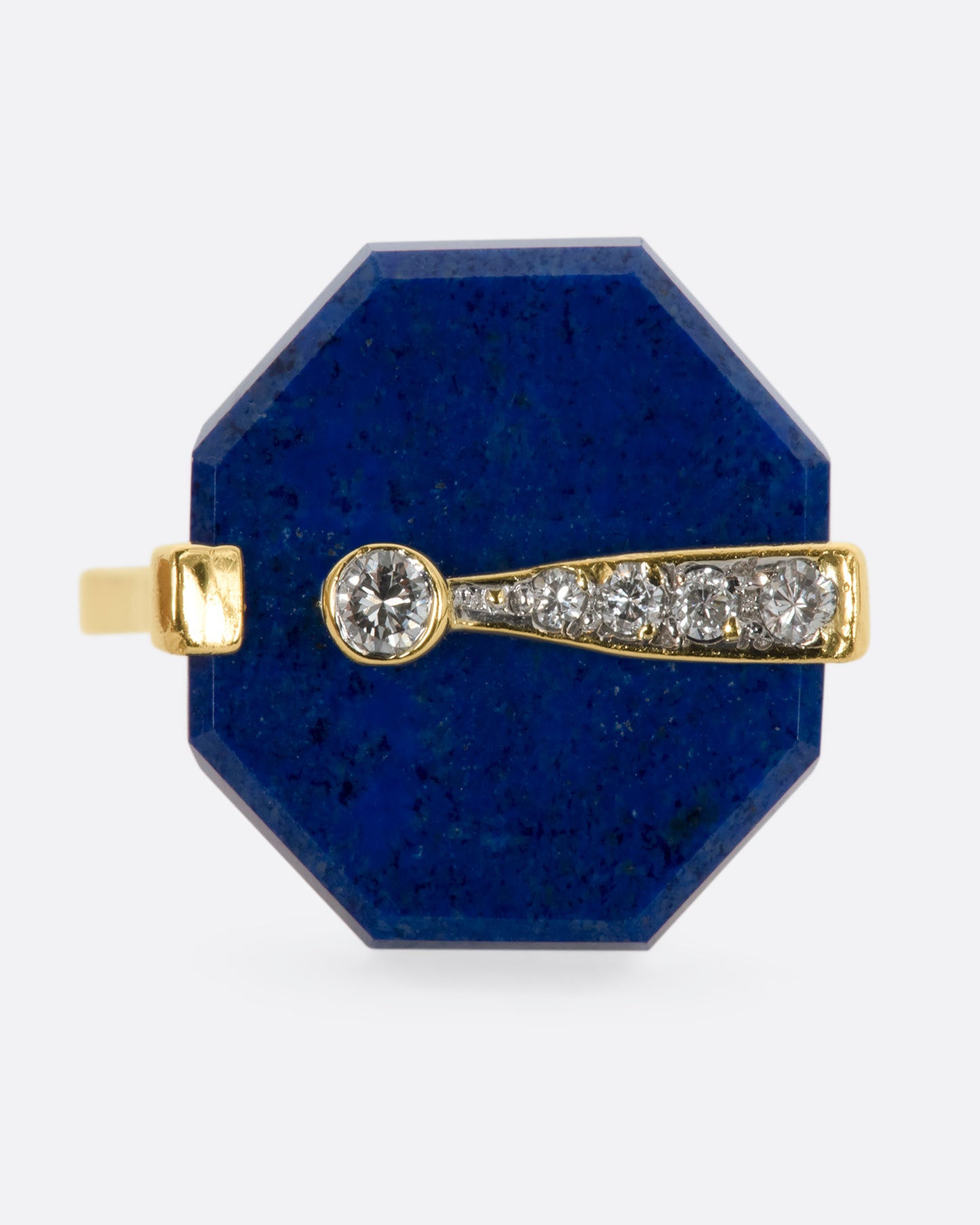 A yellow gold right with an octagonal lapis and diamond exclamation point. View close up straight on from the front.