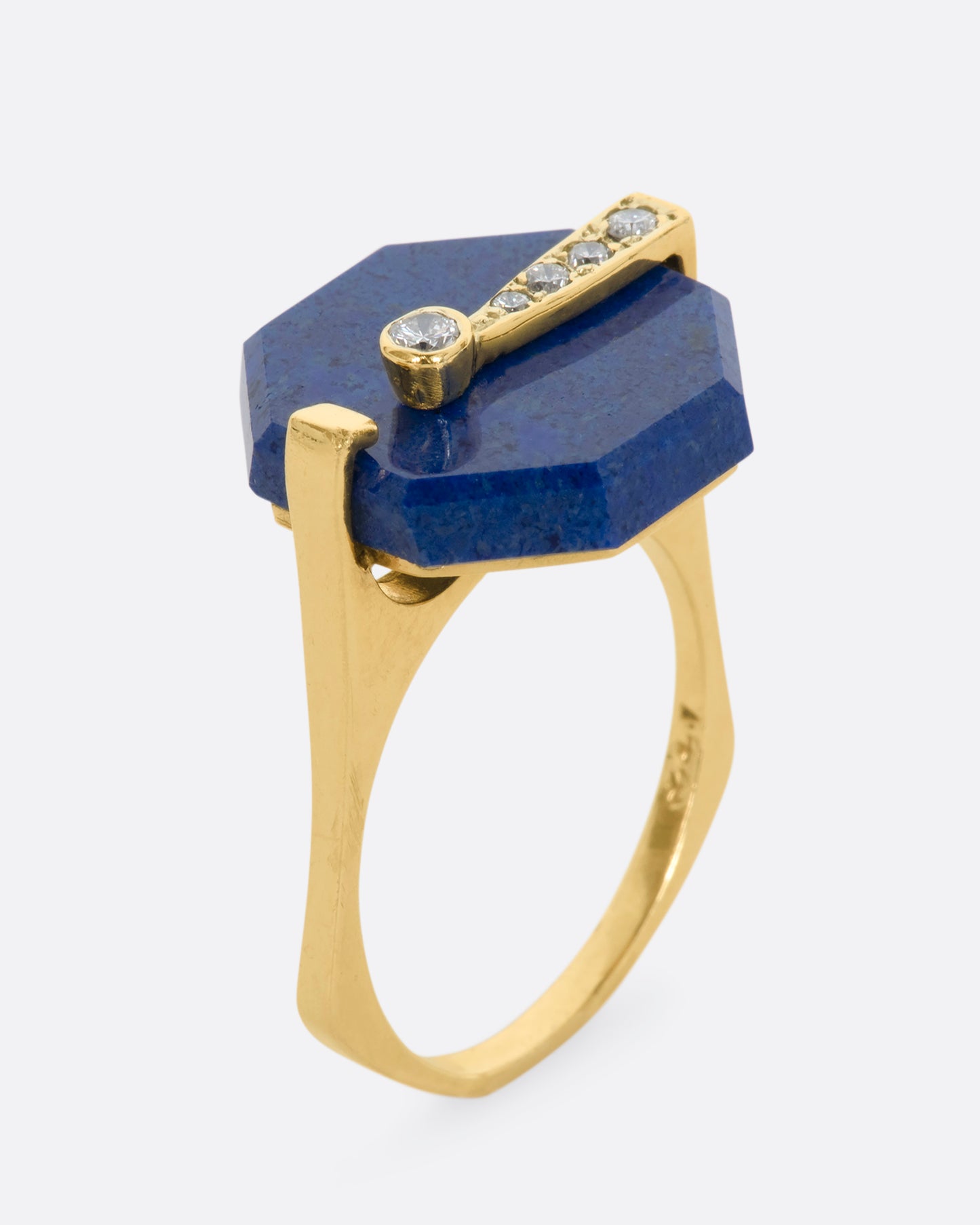 A yellow gold right with an octagonal lapis and diamond exclamation point. View from the side standing up.