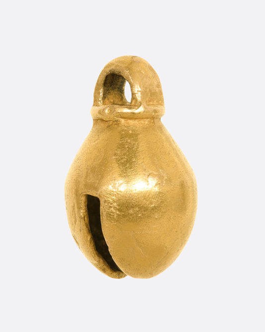 A yellow gold bell charm or pendant. View from the side.