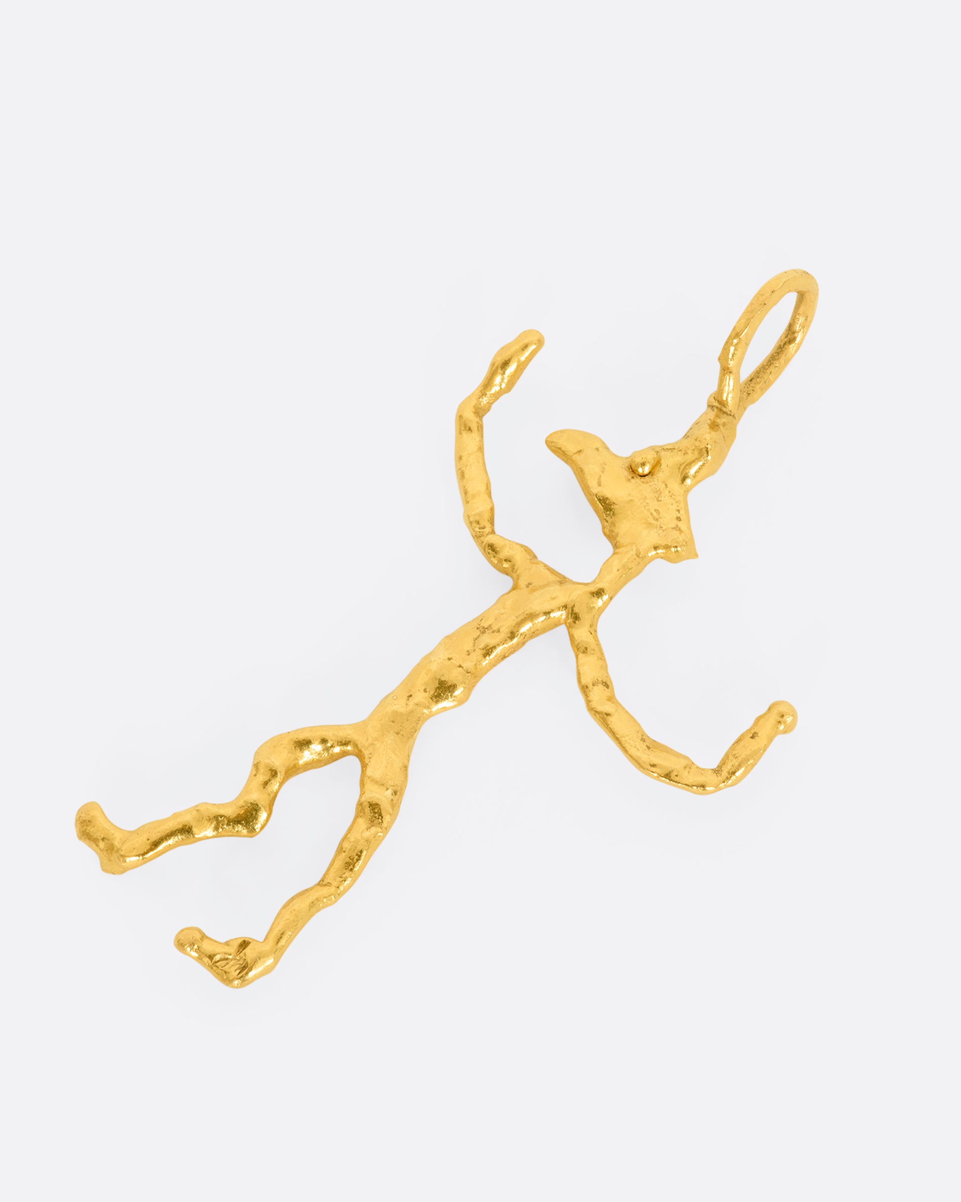 Yellow gold abstract creature pendant. Laying flat