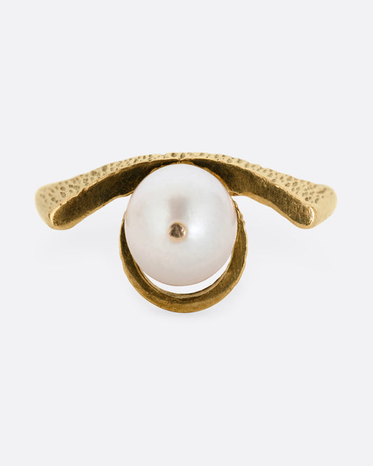A yellow gold ring with a white pearl shown from the front.