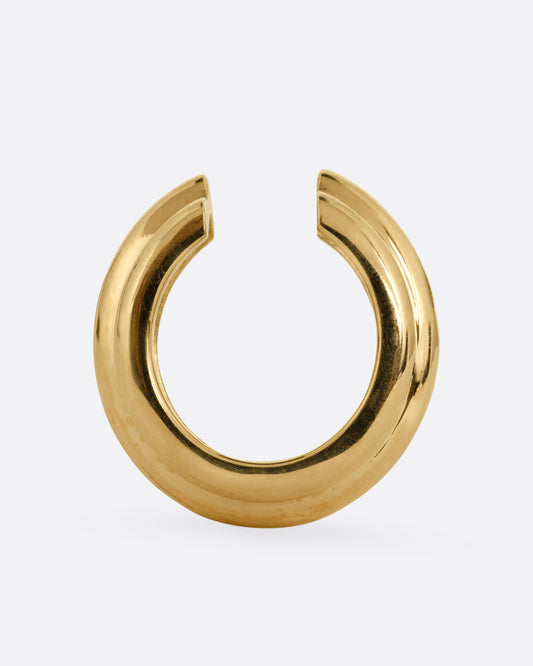 A yellow gold hoop shaped ear cuff shown from the top.