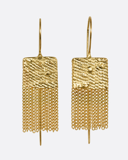 A pair of yellow gold drop earrings with square tops and cable chain fringe bottoms. Shown from the front.