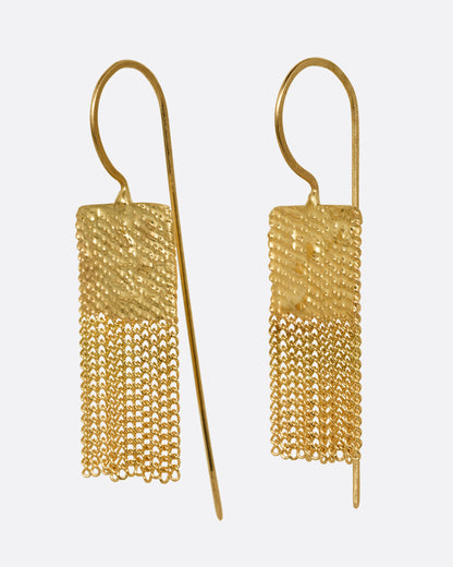 A pair of yellow gold drop earrings with square tops and cable chain fringe bottoms. Shown from the side.
