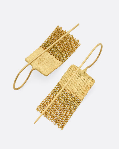 A pair of yellow gold drop earrings with square tops and cable chain fringe bottoms. Shown from the back.