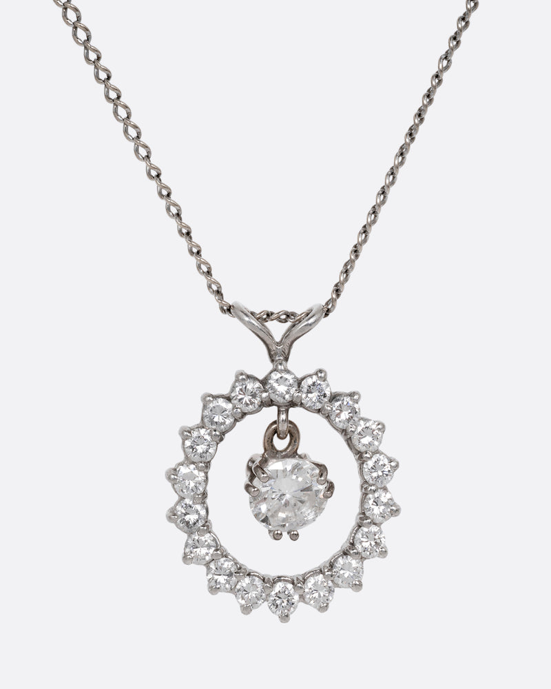 Vintage necklace in 14k white gold, a circle of round diamonds with a single diamond dangling at the center, on a fine chain