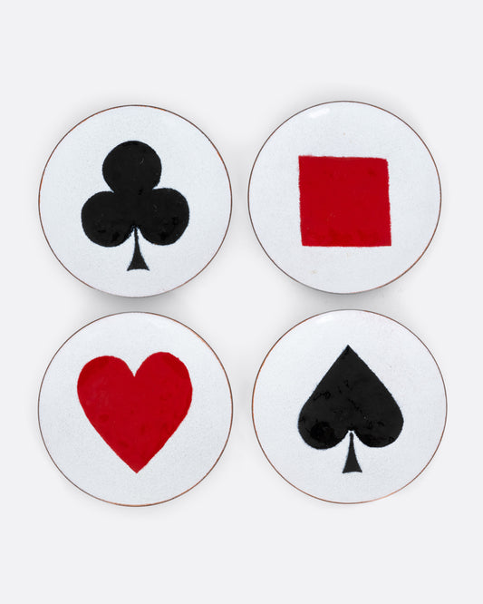 A set of four enamel plates with playing card suits, shown from the top.