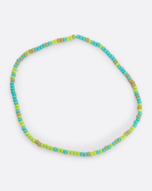 A stretchy bracelet with seed beads in turquoise and olive.