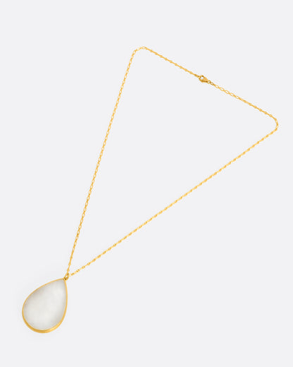 Yellow gold moonstone teardrop necklace laid flat, showing the chain length and teardrop pendant
