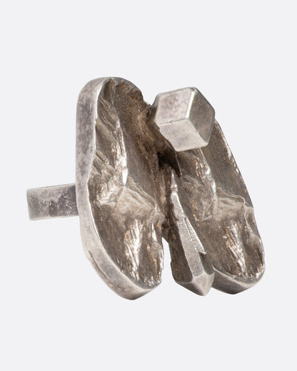 A silver abstract butterfly ring shown from the side.