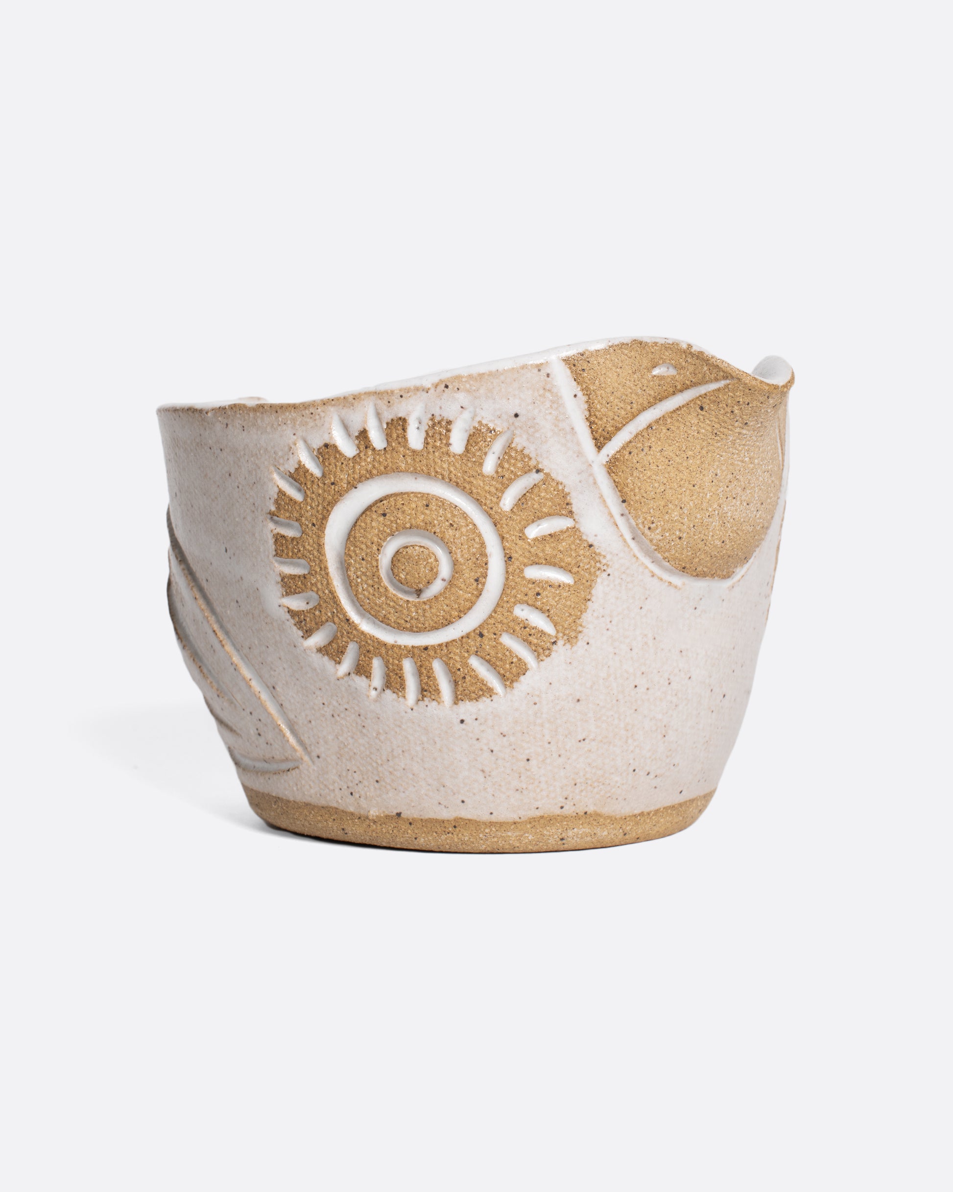 A handmade ceramic bird bowl whose beak serves as a spout, perfect for mixing and serving your favorite salad dressing.