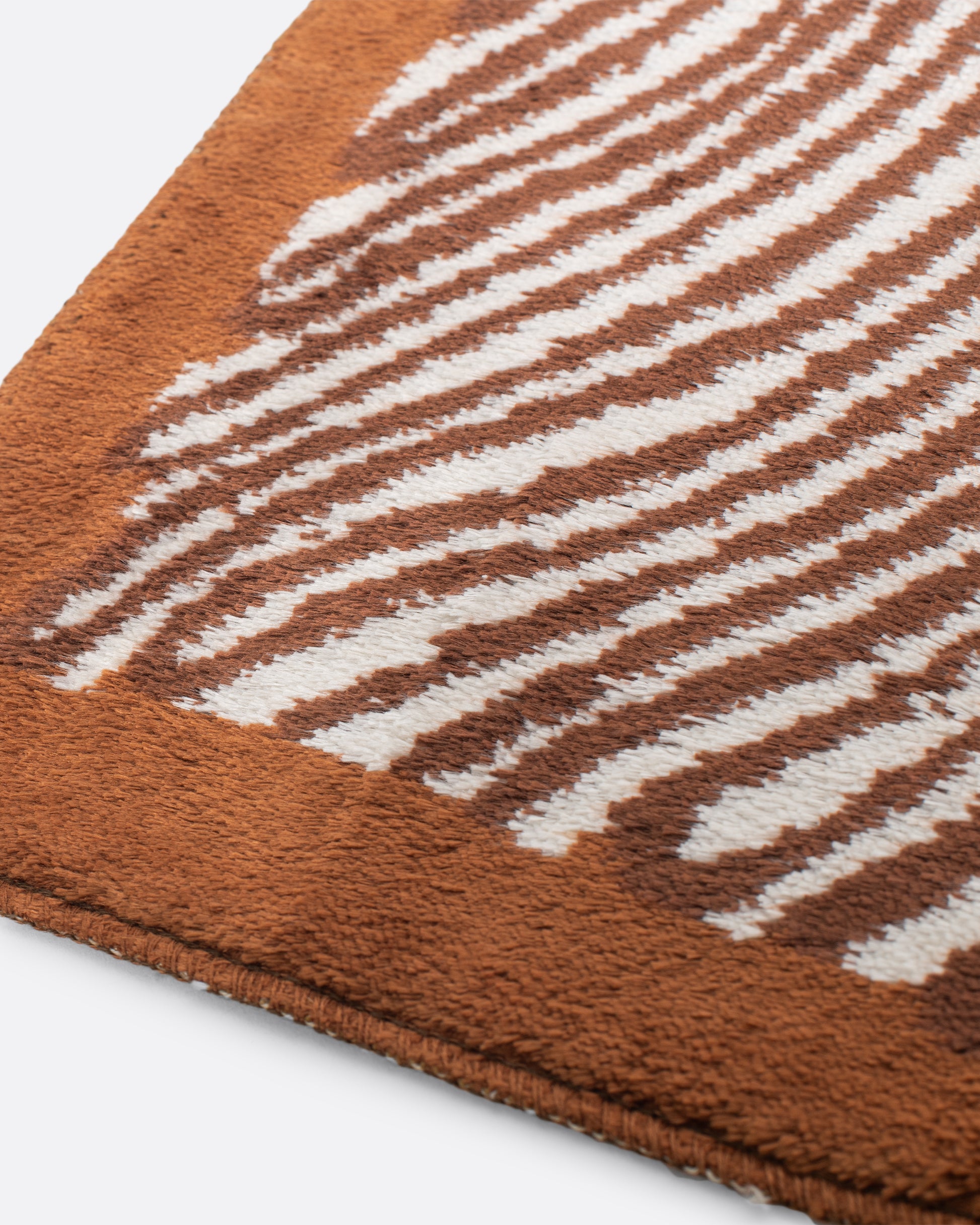 A unique Hungarian mid-century modern rug featuring organic white and brown lines intertwined with an array of orange and brown circles that look like treasures hidden among layers of rock