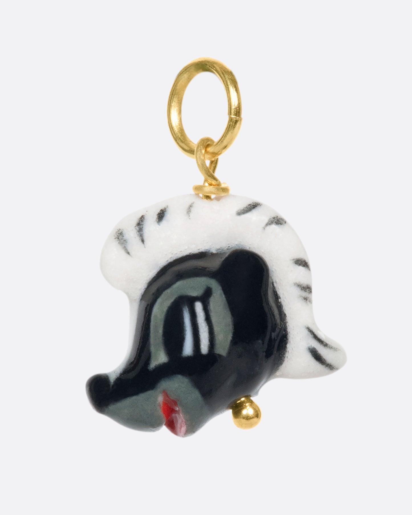 A handmade and painted porcelain Flower the Skunk charm with a 14k gold bail.