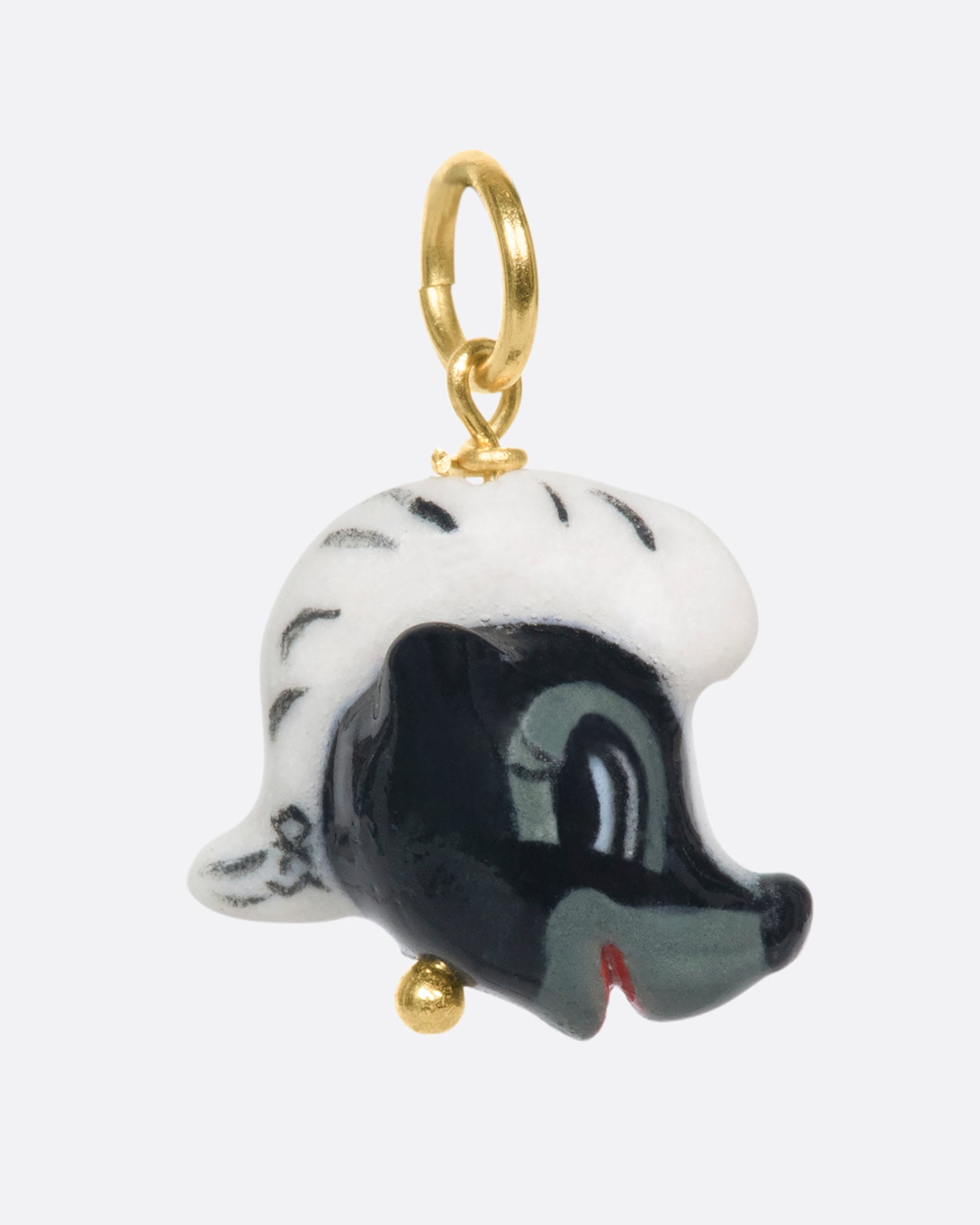 A handmade and painted porcelain Flower the Skunk charm with a 14k gold bail.