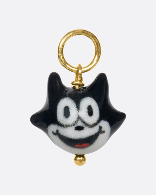 A handmade and painted porcelain Felix the Cat charm with a 14k gold bail