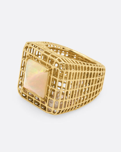 Yellow gold and opal cage ring, side view with the opal facing left