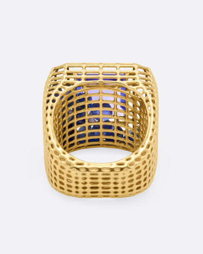 Yellow gold and tanzanite cage ring, inside view through the band showing the blue sapphires caught in the cage