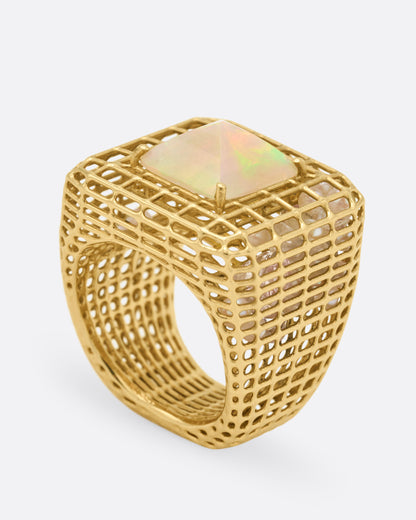 Yellow gold and opal cage ring, angled view showing the opal set high on the gold cage dome