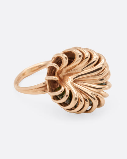 Rose gold swirl cage ring with emerald and tourmaline, side view of the swirling wire cage on a slim double band