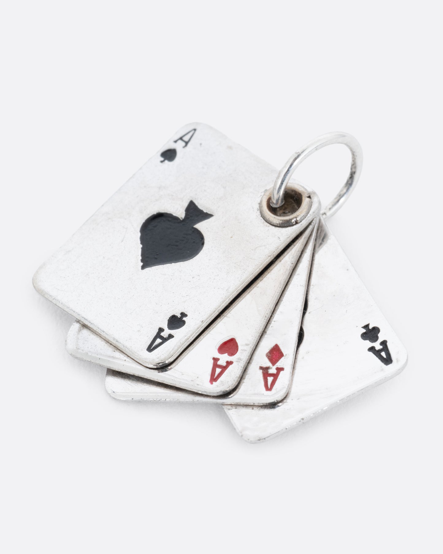 A silver playing card charm with four aces, shown from the front.