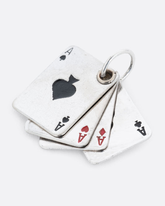 A silver playing card charm with four aces, shown from the front.