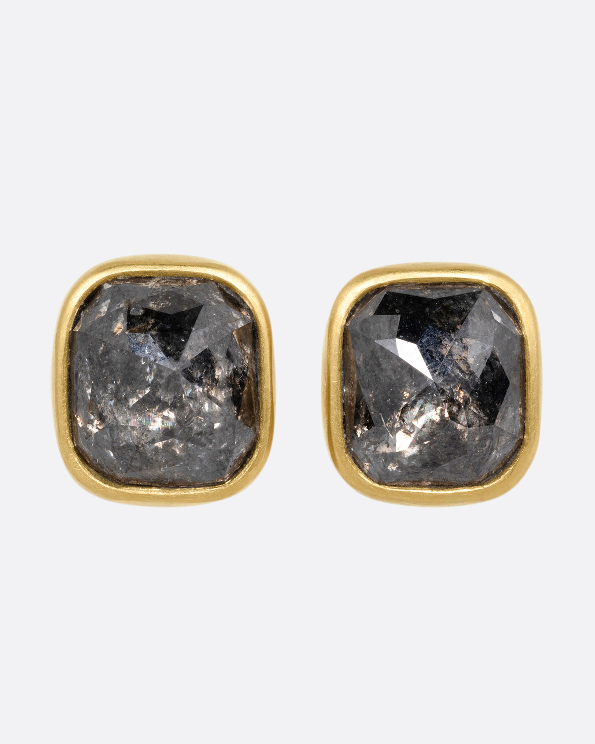 A pair of yellow gold square salt and pepper stud earrings, shown from the front.