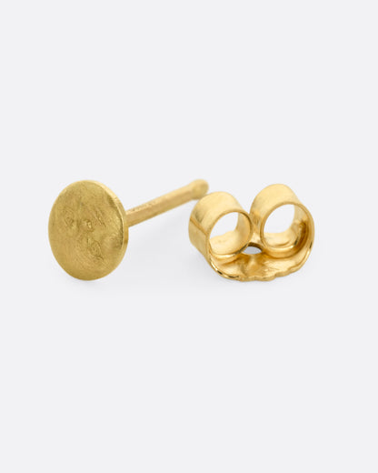 A yellow gold moon face stud earring. Shown from the side open.